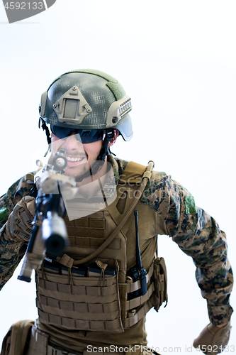 Image of soldier in action aiming laseer sight optics