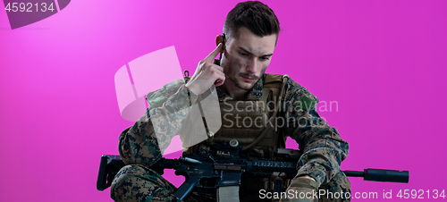 Image of soldier preparing gear for action and checking communication