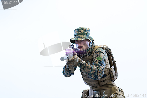 Image of soldier in action aiming laseer sight optics