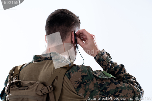 Image of soldier preparing gear for action and checking communication