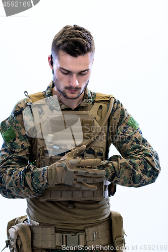 Image of closeup of soldier hands putting protective battle gloves