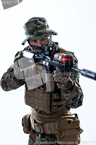 Image of soldier in action aiming laseer sight optics