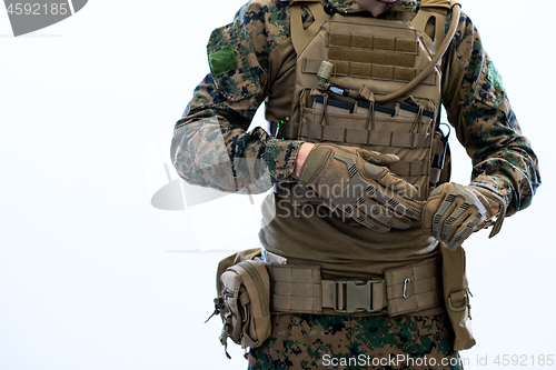 Image of closeup of soldier hands putting protective battle gloves