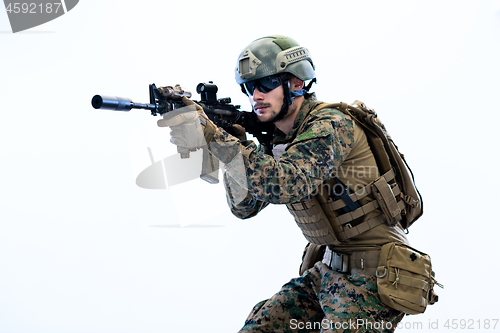 Image of soldier in action aiming laseer sight optics