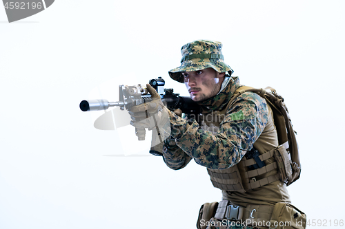 Image of soldier in action aiming laseer sight optics