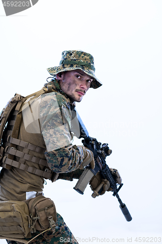 Image of soldier in action aiming laseer sight optics