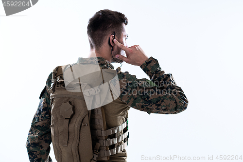 Image of soldier preparing gear for action and checking communication