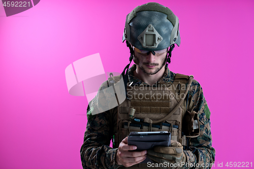 Image of soldier using tablet computer closeup