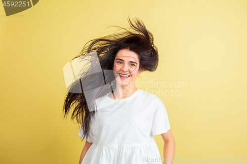 Image of Easter bunny woman with bright emotions on yellow studio background