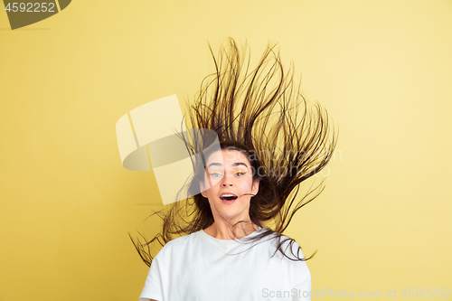 Image of Easter bunny woman with bright emotions on yellow studio background