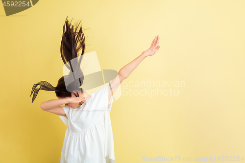 Image of Easter bunny woman with bright emotions on yellow studio background