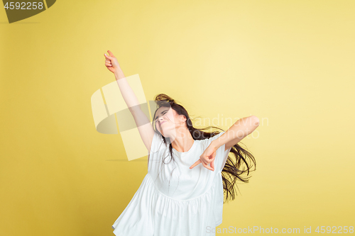 Image of Easter bunny woman with bright emotions on yellow studio background