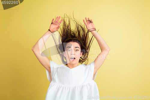 Image of Easter bunny woman with bright emotions on yellow studio background