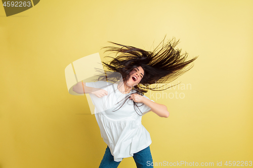 Image of Easter bunny woman with bright emotions on yellow studio background