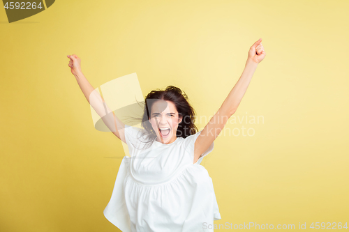 Image of Easter bunny woman with bright emotions on yellow studio background