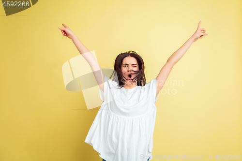 Image of Easter bunny woman with bright emotions on yellow studio background