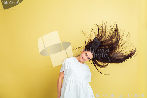 Image of Easter bunny woman with bright emotions on yellow studio background