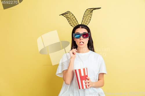 Image of Easter bunny woman with bright emotions on yellow studio background