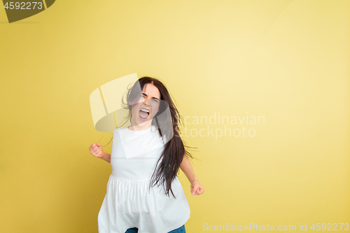 Image of Easter bunny woman with bright emotions on yellow studio background