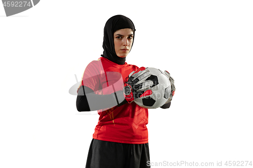 Image of Arabian female soccer or football player, goalkeeper on white studio background