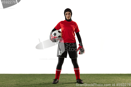 Image of Arabian female soccer or football player, goalkeeper on white studio background