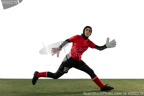 Image of Arabian female soccer or football player, goalkeeper on white studio background