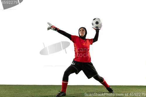 Image of Arabian female soccer or football player, goalkeeper on white studio background