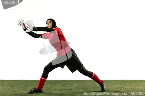 Image of Arabian female soccer or football player, goalkeeper on white studio background