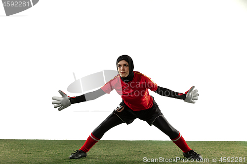 Image of Arabian female soccer or football player, goalkeeper on white studio background