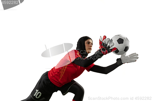 Image of Arabian female soccer or football player, goalkeeper on white studio background