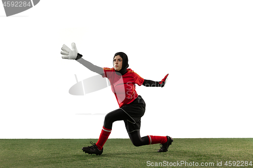 Image of Arabian female soccer or football player, goalkeeper on white studio background