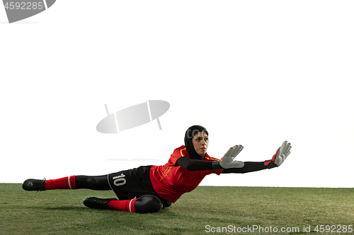 Image of Arabian female soccer or football player, goalkeeper on white studio background