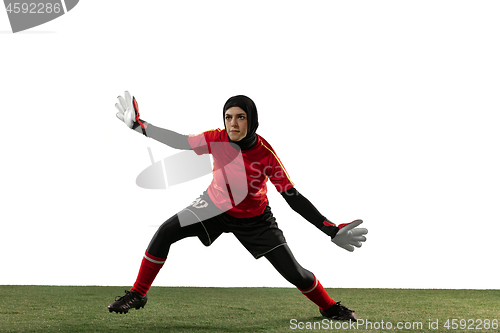 Image of Arabian female soccer or football player, goalkeeper on white studio background