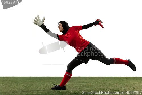 Image of Arabian female soccer or football player, goalkeeper on white studio background