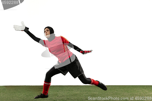 Image of Arabian female soccer or football player, goalkeeper on white studio background