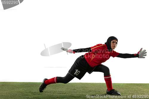 Image of Arabian female soccer or football player, goalkeeper on white studio background