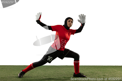 Image of Arabian female soccer or football player, goalkeeper on white studio background