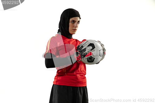 Image of Arabian female soccer or football player, goalkeeper on white studio background