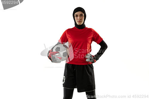 Image of Arabian female soccer or football player, goalkeeper on white studio background