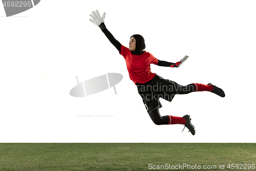 Image of Arabian female soccer or football player, goalkeeper on white studio background