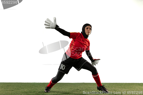 Image of Arabian female soccer or football player, goalkeeper on white studio background