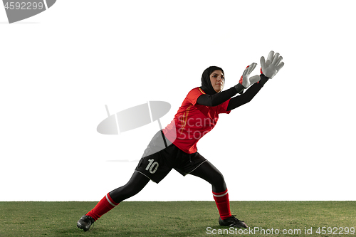 Image of Arabian female soccer or football player, goalkeeper on white studio background