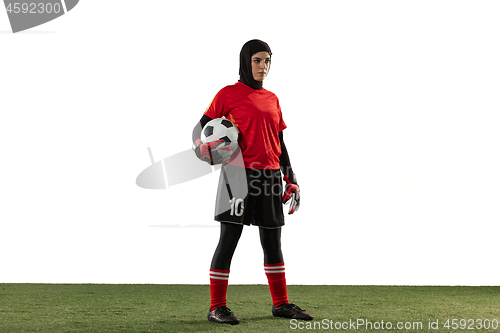 Image of Arabian female soccer or football player, goalkeeper on white studio background