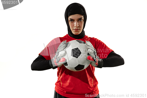 Image of Arabian female soccer or football player, goalkeeper on white studio background