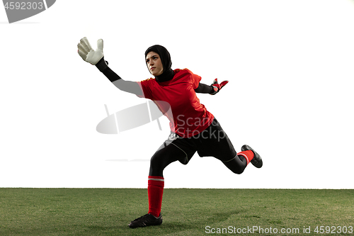 Image of Arabian female soccer or football player, goalkeeper on white studio background