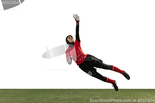 Image of Arabian female soccer or football player, goalkeeper on white studio background