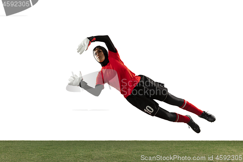 Image of Arabian female soccer or football player, goalkeeper on white studio background