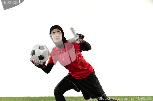 Image of Arabian female soccer or football player, goalkeeper on white studio background