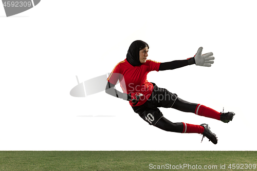 Image of Arabian female soccer or football player, goalkeeper on white studio background