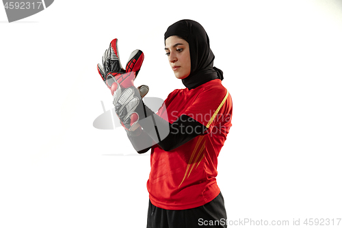 Image of Arabian female soccer or football player, goalkeeper on white studio background